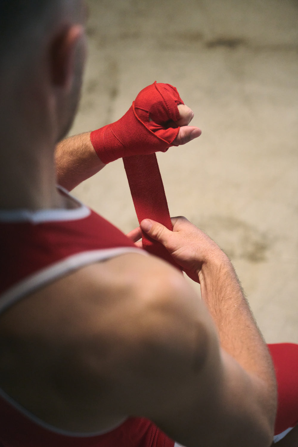 TITLE Boxing South Africa red woven cotton hand wraps being applied by a boxer for wrist support and knuckle protection