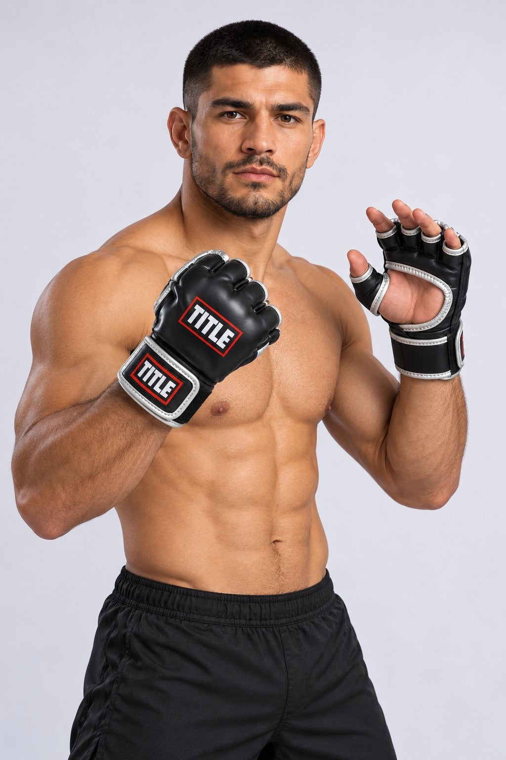 Fighter with one hand open, showing the open palm and free fingers of TITLE black and silver Powerhide MMA gloves