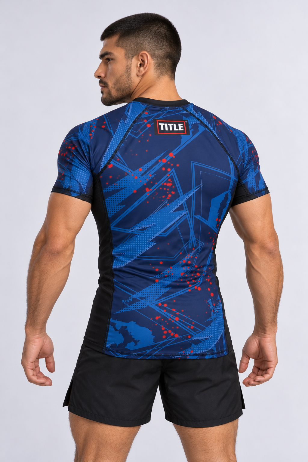 Back view of an MMA athlete in the TITLE Chaos short-sleeve rash guard with the TITLE logo between the shoulders