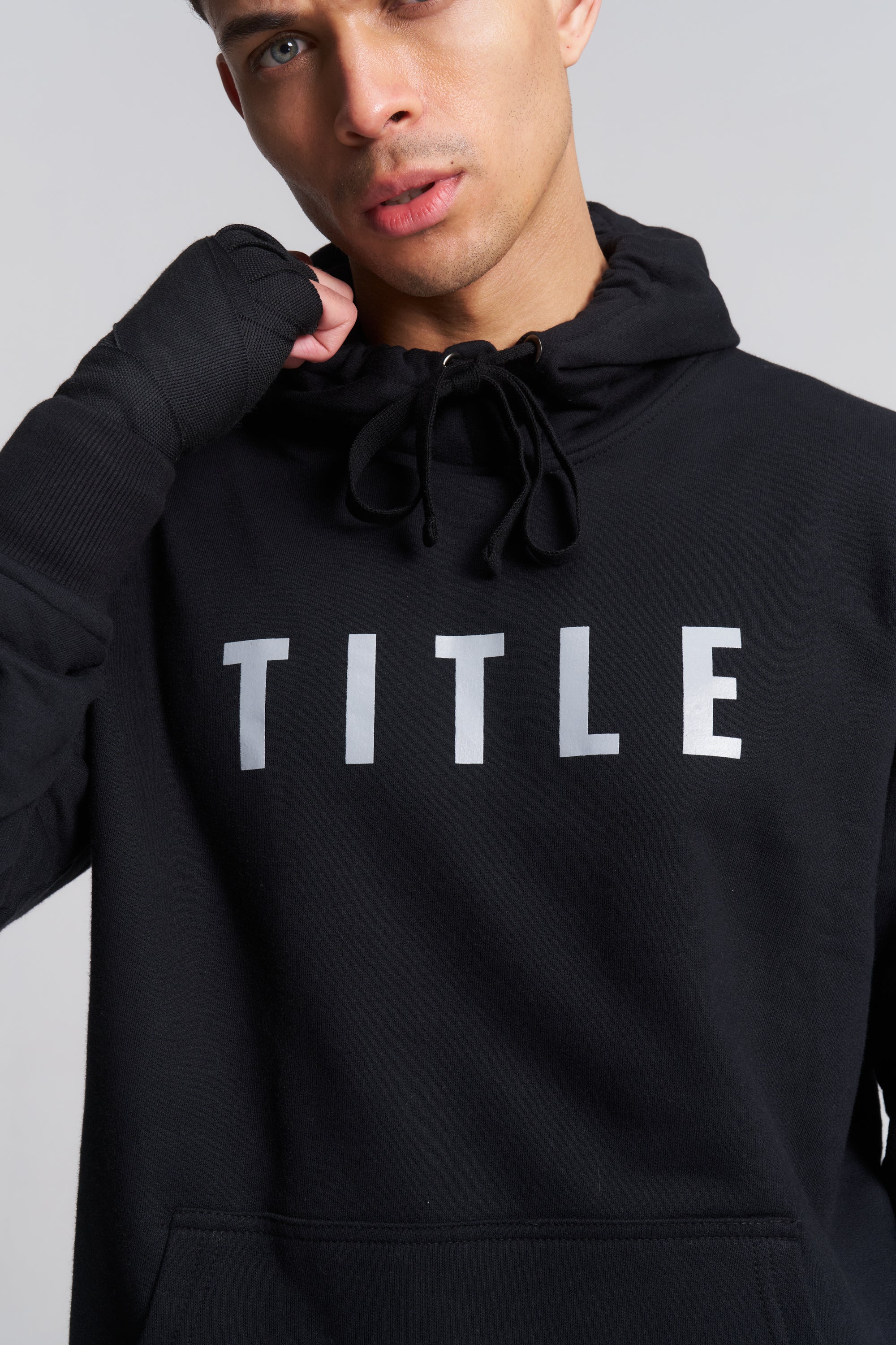 TITLE Boxing South Africa black heavyweight cotton hoodie with grey chest logo worn by a male athlete with hand wraps