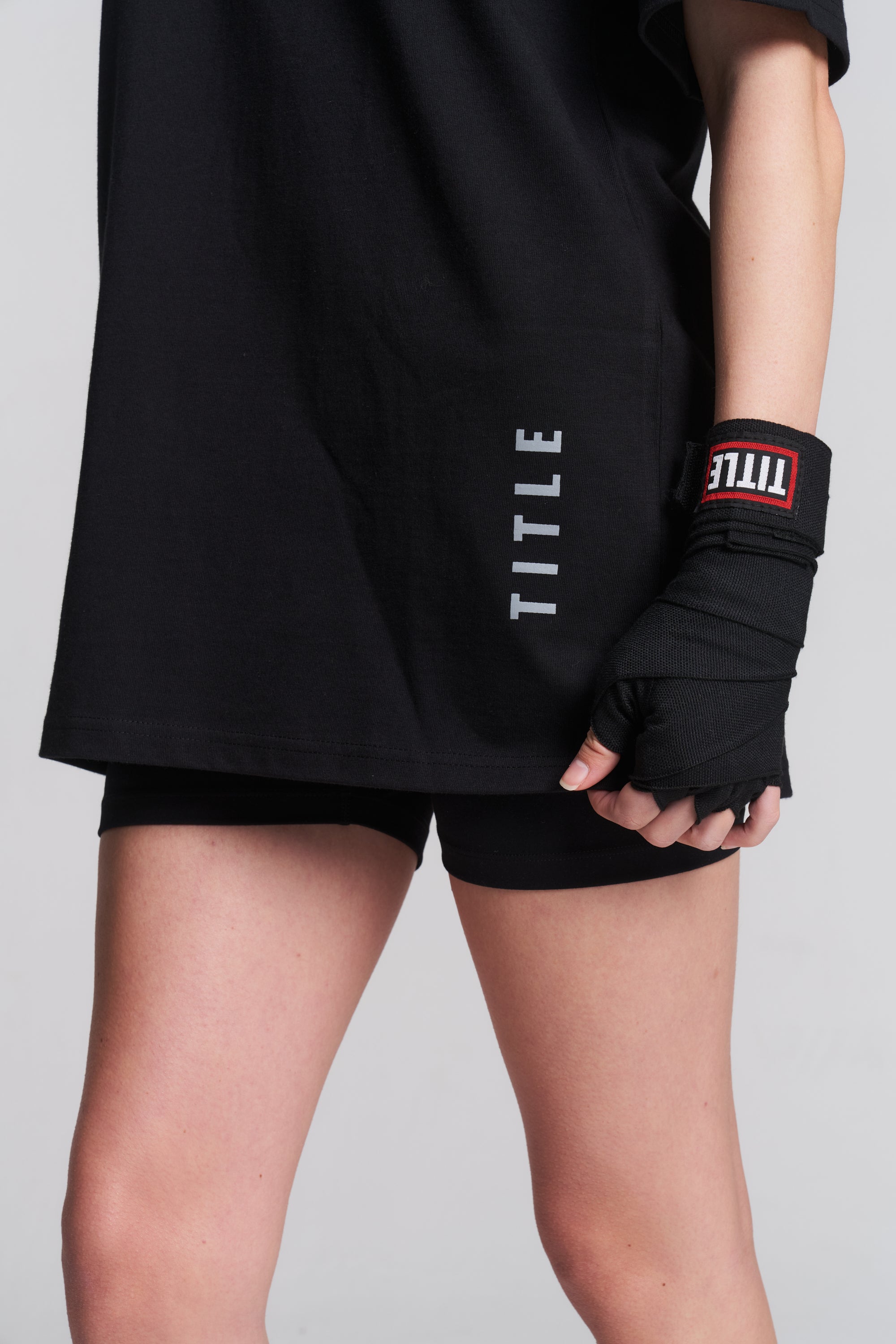 TITLE Boxing South Africa black woven cotton hand wraps worn on a fighter's wrist with a secure hook-and-loop closure.