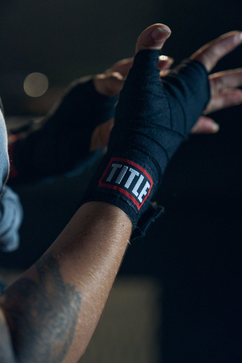 TITLE Boxing South Africa black woven cotton hand wraps with hook-and-loop closure worn on a fighter's hands