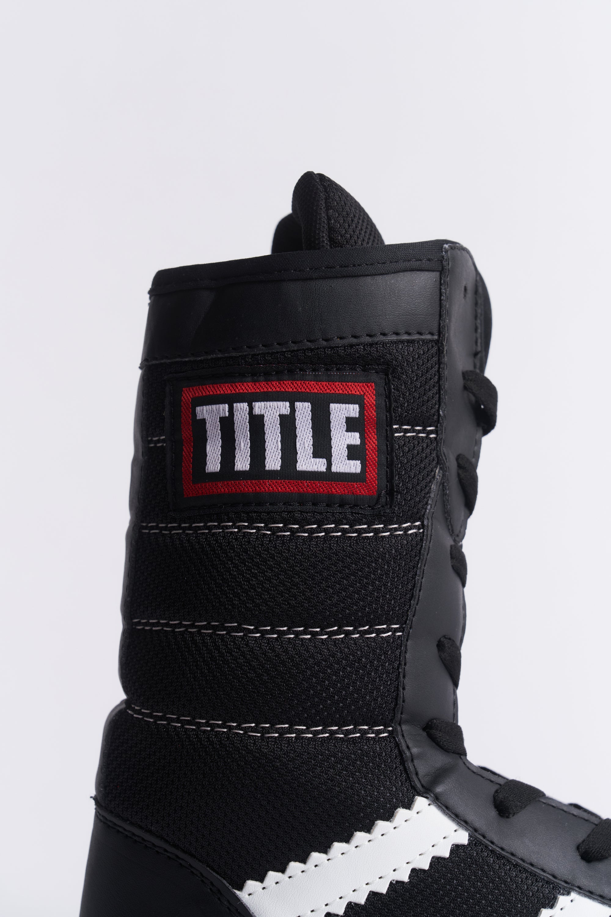 TITLE Boxing South Africa black high-top boxing boots featuring PU leather, nylon mesh, and a red brand logo patch.