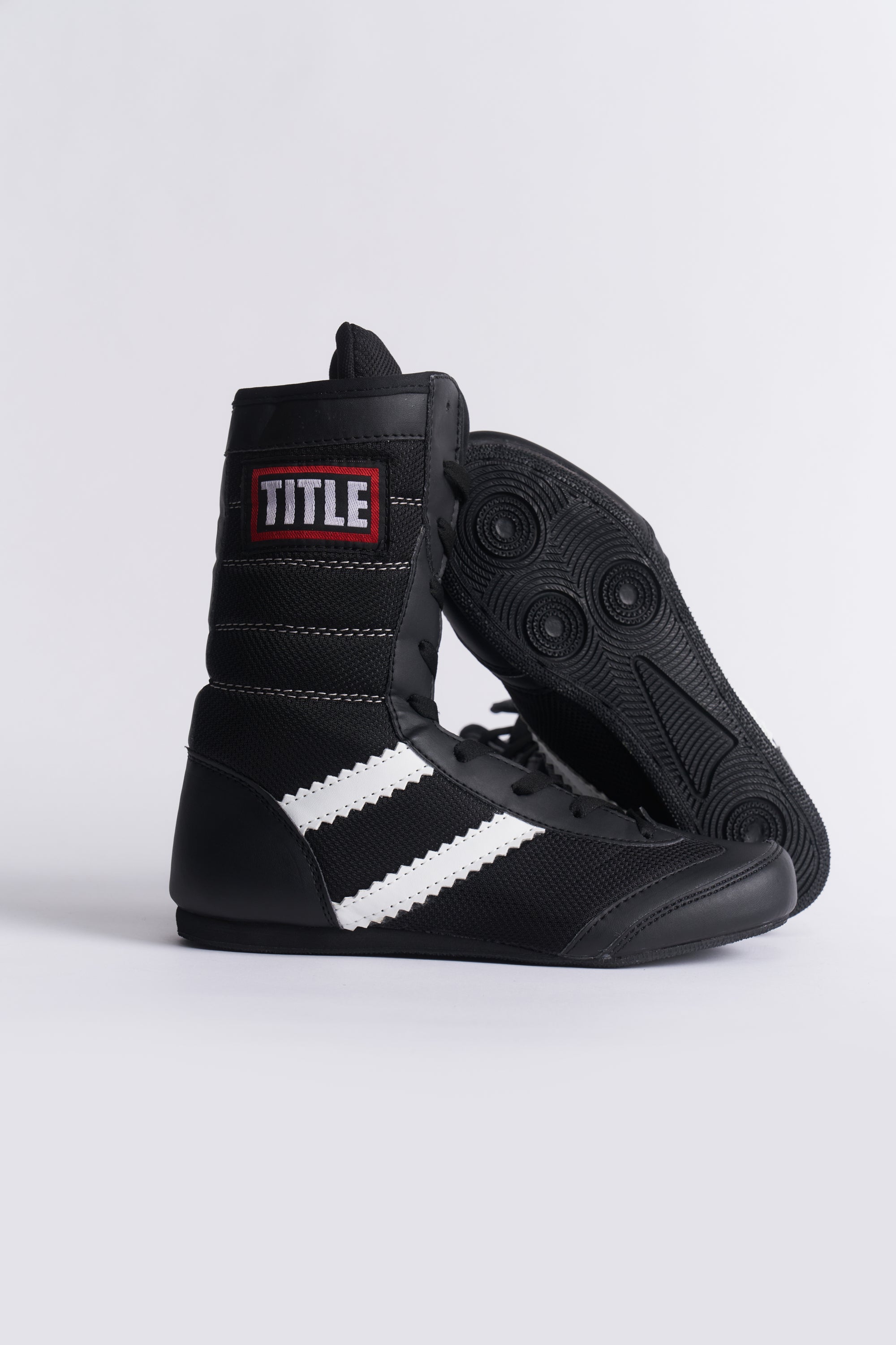 TITLE Boxing South Africa black high-top boxing boots with white side stripes and responsive rubber pivot soles