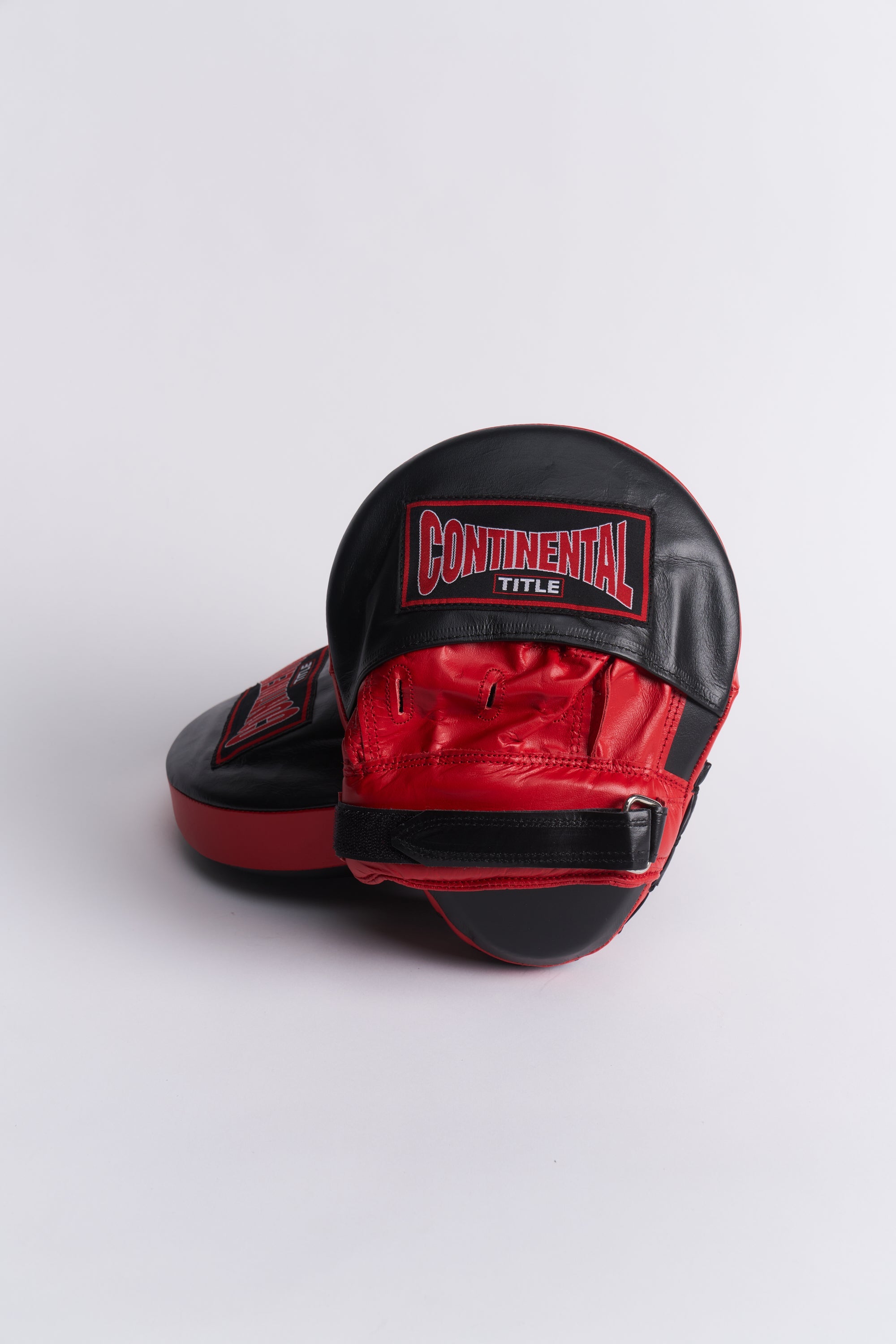 TITLE Boxing South Africa leather curved hook and jab pads with red and black design and adjustable wrist strap.