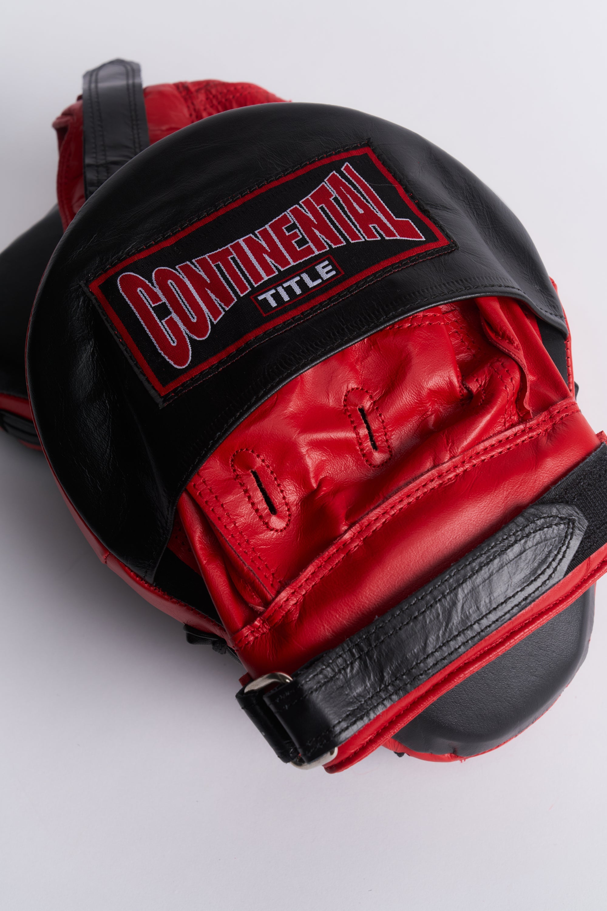 TITLE Boxing South Africa curved leather hook and jab pads with a small target face and adjustable hook-and-loop strap