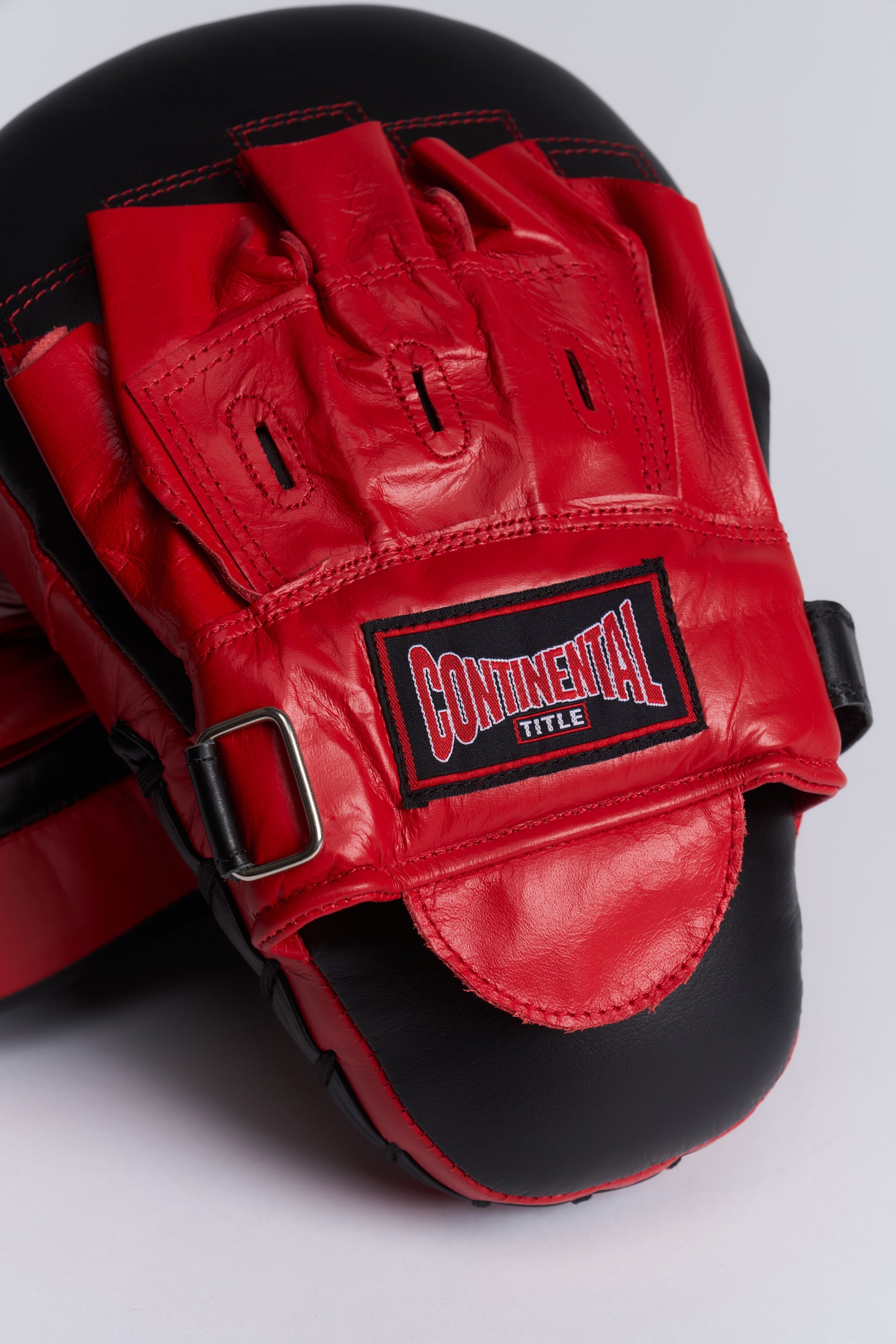 TITLE Boxing South Africa curved leather hook and jab pads with red and black finish and adjustable wrist strap
