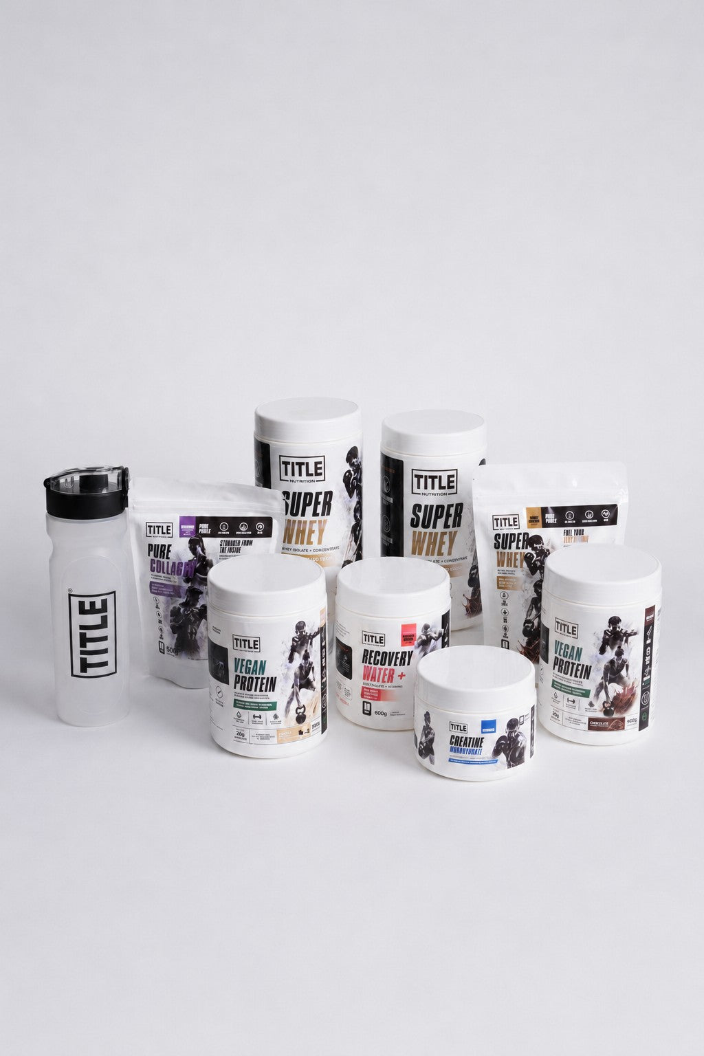TITLE Boxing South Africa Forged Shaker bottle next to a collection of various TITLE Nutrition protein supplement tubs