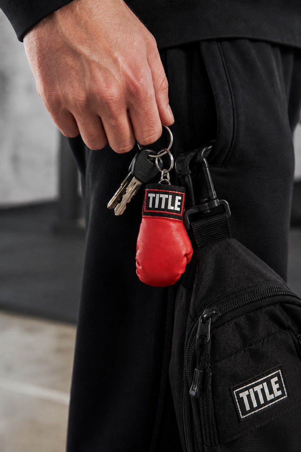 TITLE Boxing South Africa red miniature boxing glove keychain attached to a set of keys on a black bag