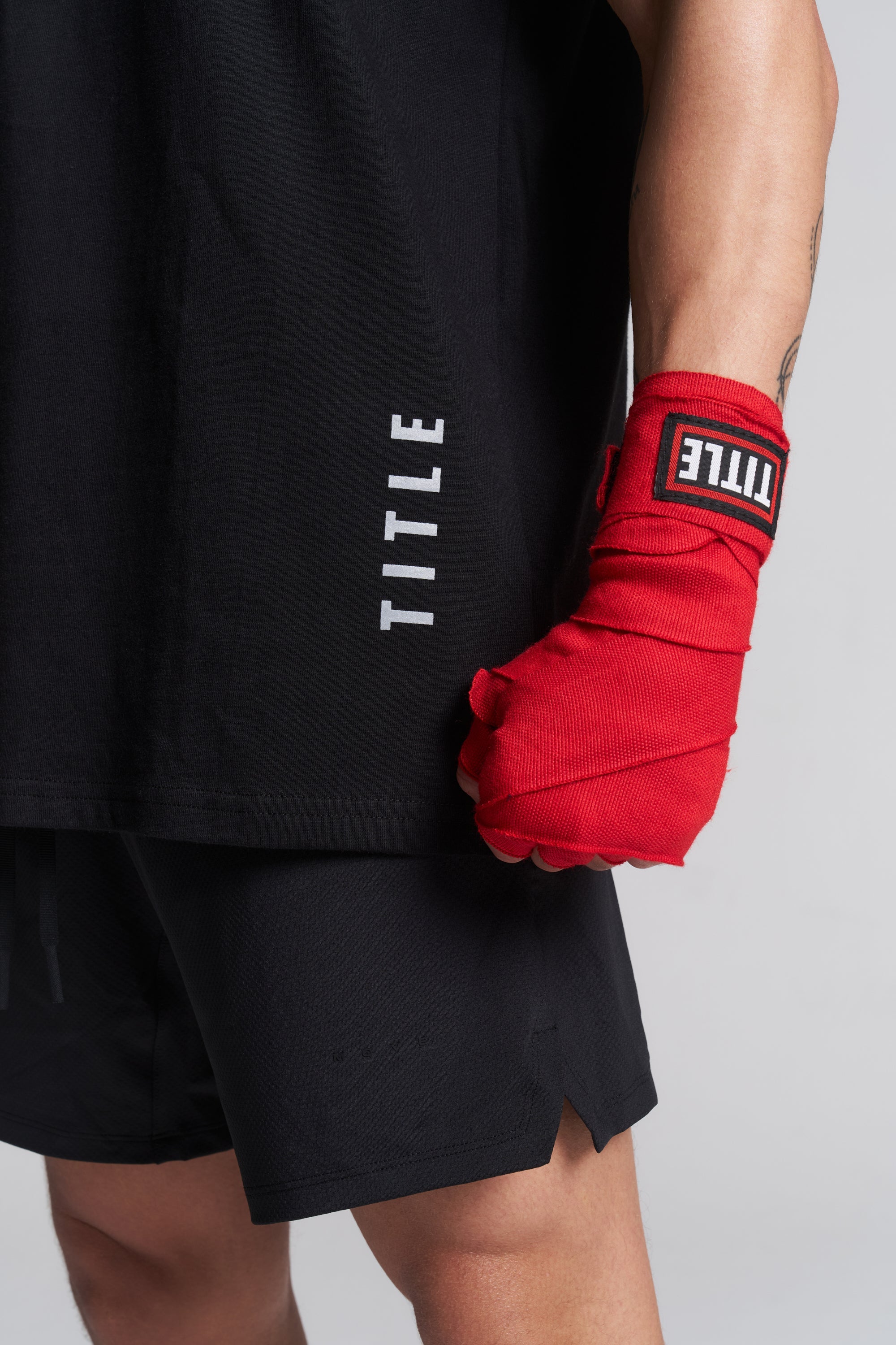 TITLE Boxing South Africa red woven cotton hand wraps worn by a boxer with a black branded shirt